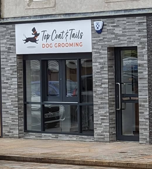 Dark-framed salon window at the Wemyss Buildings premises